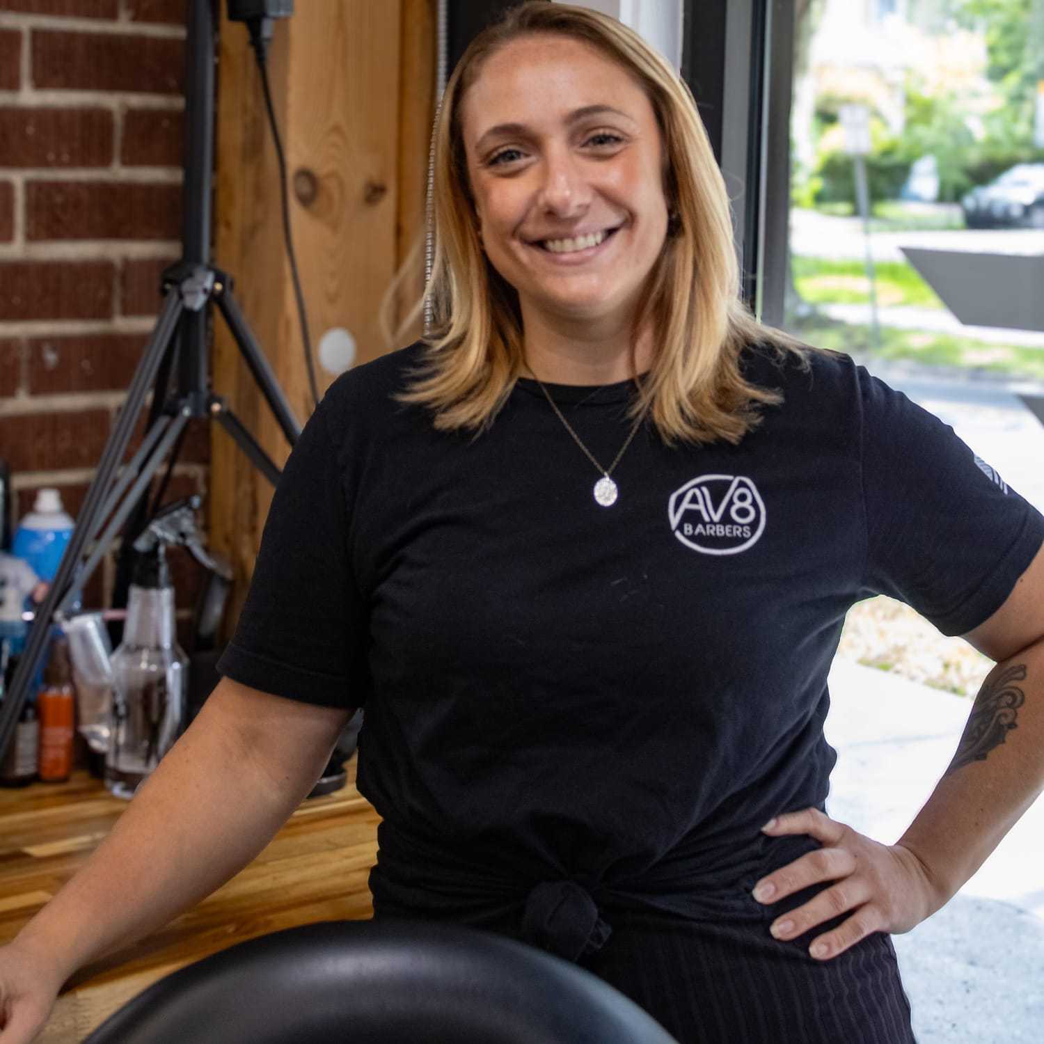 Portrait of Victoria, a professional stylist at Av8 Barbers, showcasing their expertise and style.