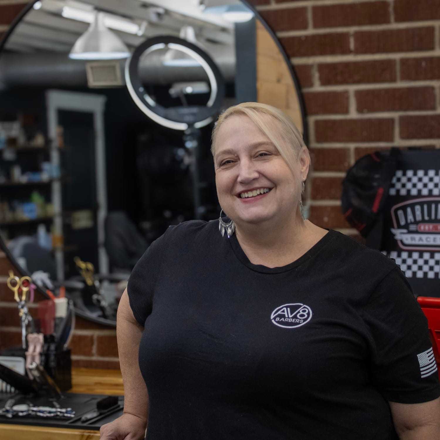 Portrait of Elizabeth, a professional stylist at Av8 Barbers, showcasing their expertise and style.