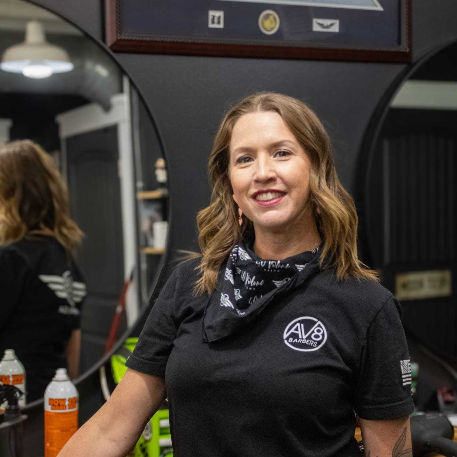 Portrait of Alisha, a professional stylist at Av8 Barbers, showcasing their expertise and style.